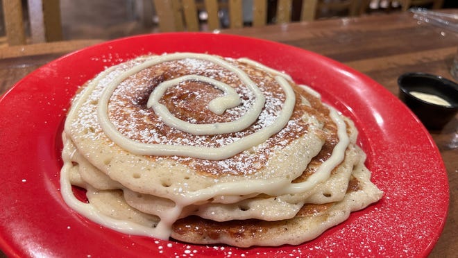 Cinnamon Roll Flapjacks at Joe Louis Southern Kitchen are traced with a drizzle of cream cheese frosting.