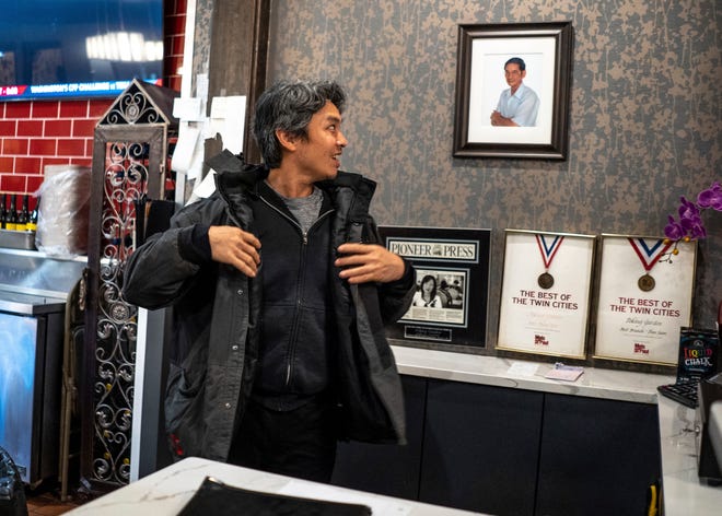 Jeff Wu, 47, of Lakeville, Minnesota talks about a photo of his father hanging at his family owned restaurant called Peking Garden in St. Paul, Minnesota on Wednesday, December 6, 2023, while preparing to head home.