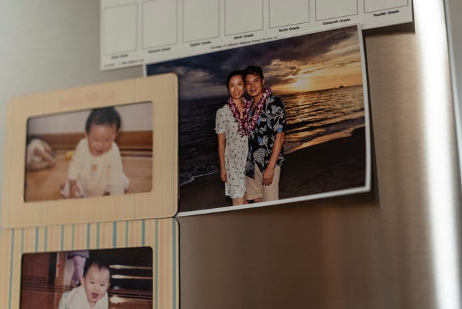 A vacation photo of Jeff Wu, 47, of Lakeville, Minnesota and his wife Ting Yang, 41, if posted on their refrigerator along with photos of their daughter at their home on Wednesday, December 6, 2023.