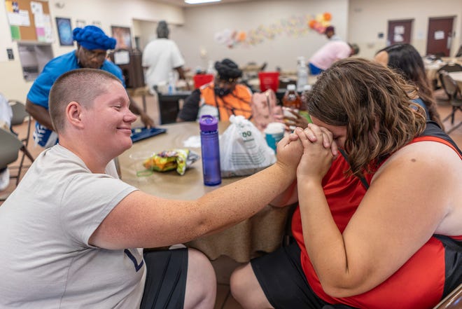 Krystal Arzadon, 29, left, sits with Kassidi Burkeen, 26, while eating at the Capuchin Soup Kitchen in Detroit on Monday, August 12, 2024.