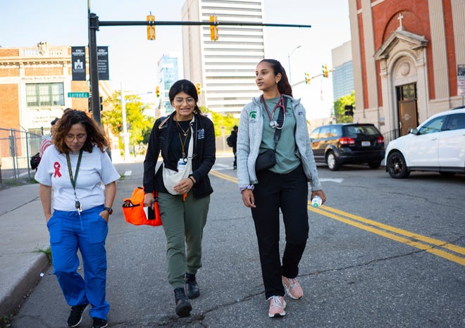 Community Health and Social Services family medicine physician Dr. Shaina Shetty, center, talks with CHASS family nurse practitioner Danny Diaz, left, and Michigan State University medical student Shalini Tummala, right, after making a stop to the Pope Francis Center in Detroit during a street medicine outreach on Monday, August 12, 2024. CHASS recently received $562,868 in American Plan Act dollars to expand its street medicine team, to aid people experiencing homelessness on the streets taking medical care right to the people who need it.