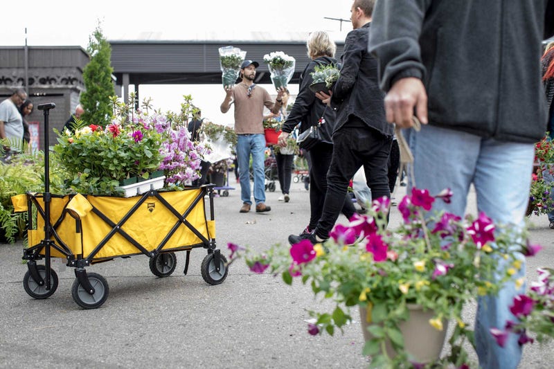 Shoppers fill the market during Flower Day at Detroit Eastern Market in Detroit on May 20, 2018.